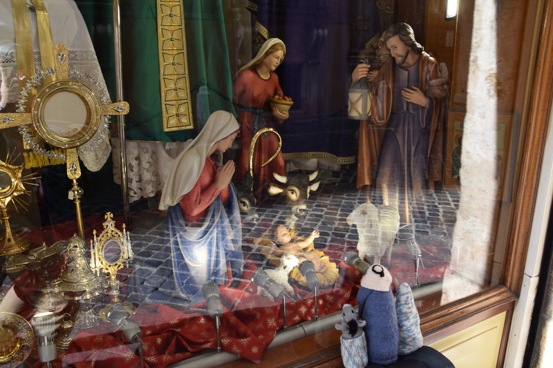 Mary Joseph and Donkey looking at a nativity